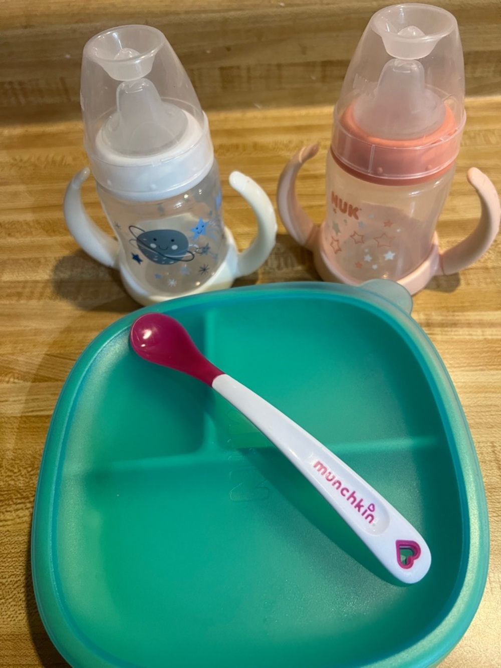 Baby sippy cups and covered dish and spoon.